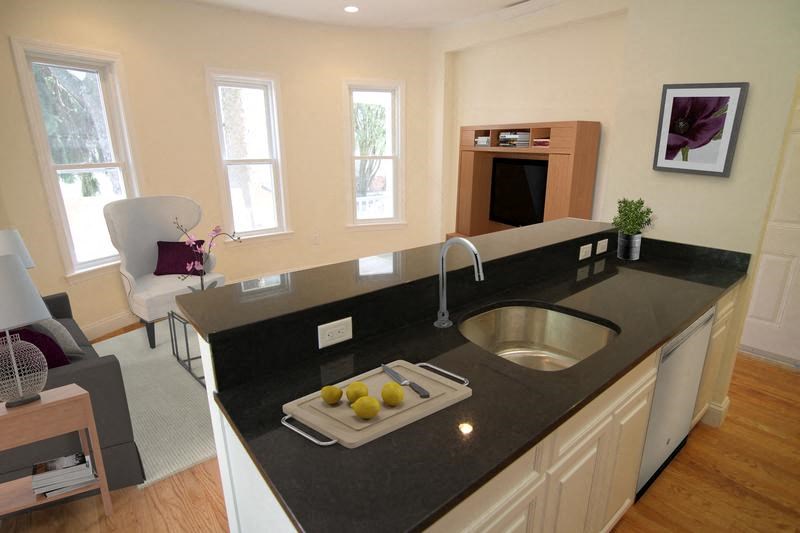 a kitchen with a black counter top and a sink