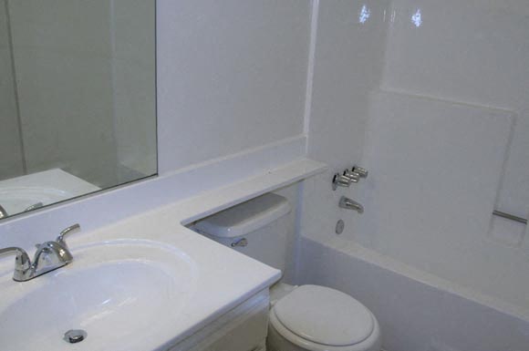 A white sink and toilet in a bathroom.