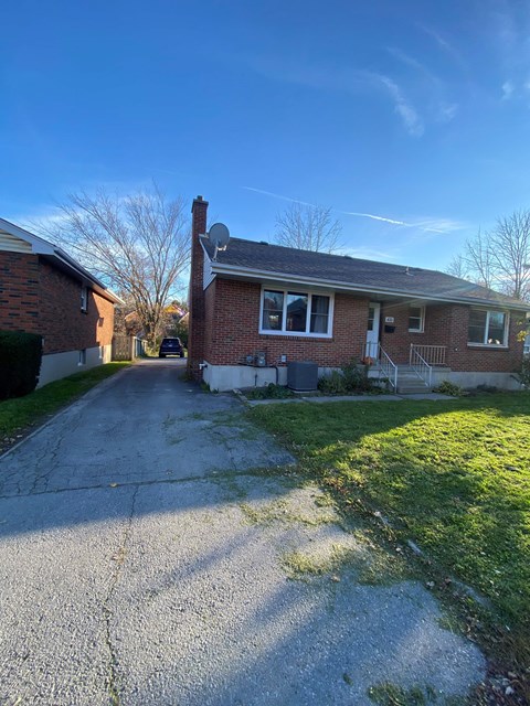 A house with a driveway in front of it.