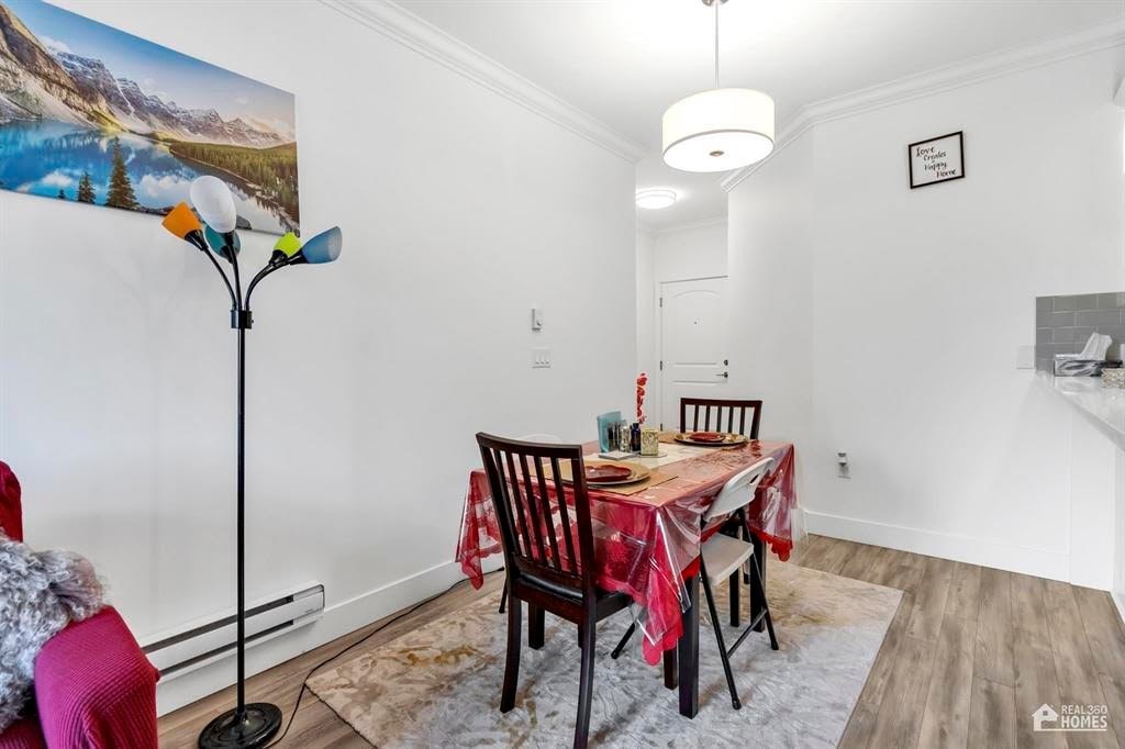 A dining room with a table set for four.