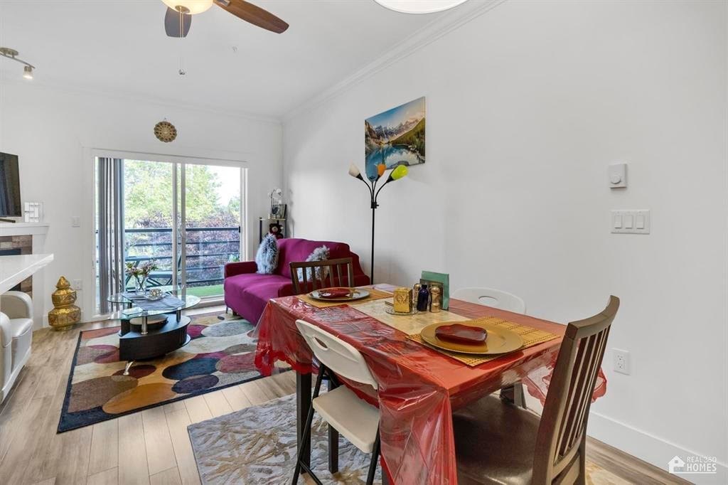 A dining room with a table set for a meal.