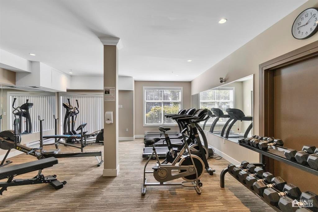 A gym with a variety of equipment including weights and exercise machines.