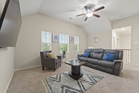 A living room with a grey couch and a coffee table.