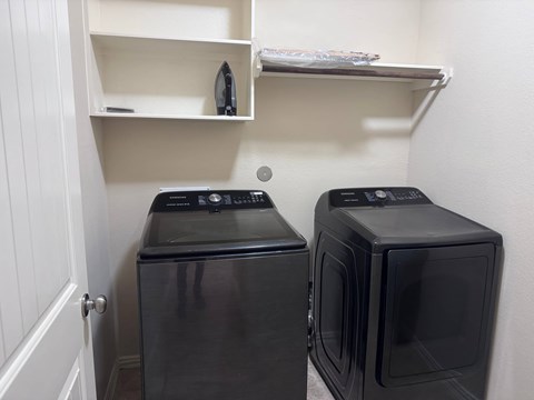 A black microwave oven is placed next to a black dishwasher in a kitchen.