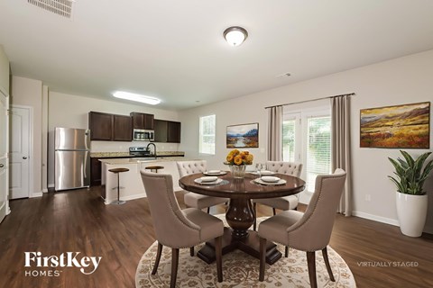 A dining room with a wooden table and chairs.