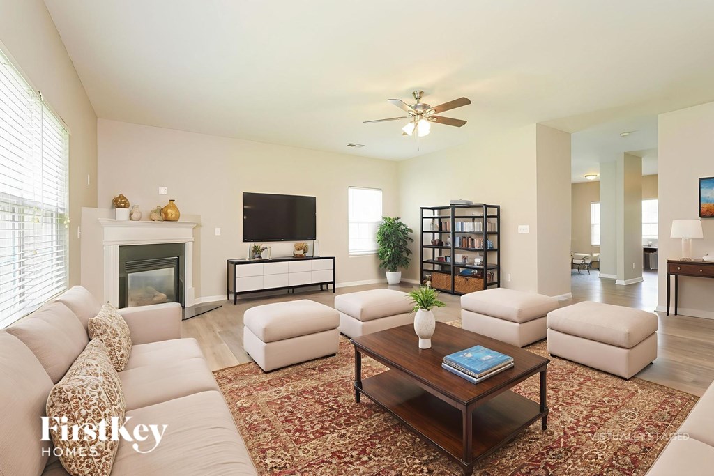 A living room with a fireplace and a bookshelf.