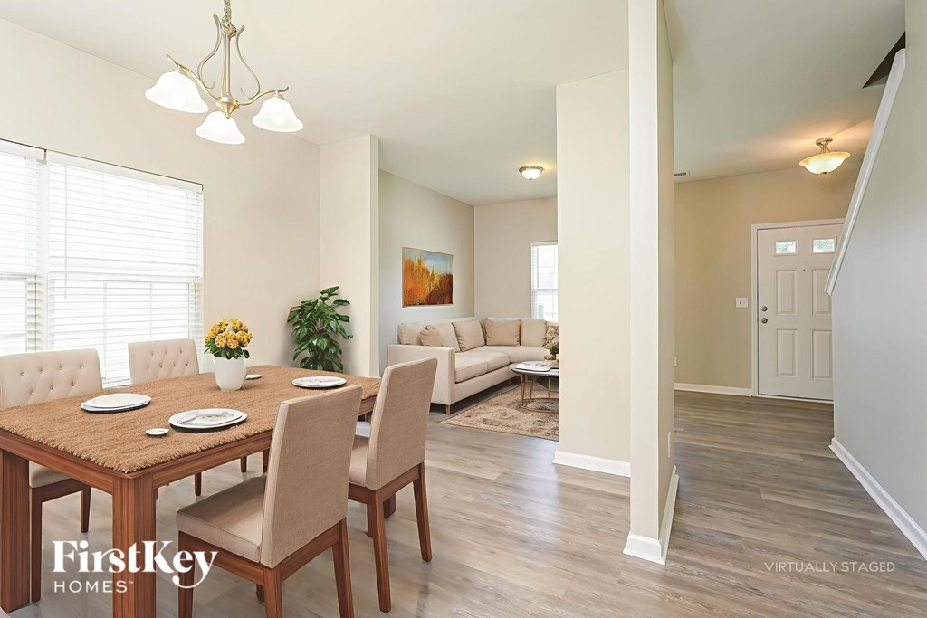 A dining room with a wooden table and chairs.