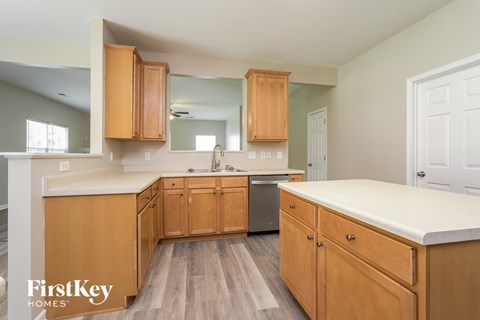 A kitchen with wooden cabinets and a white countertop.