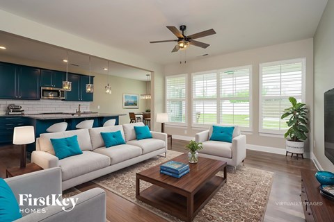 A living room with a white couch and a wooden coffee table.