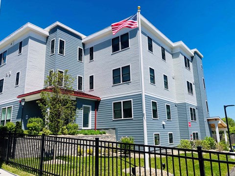 A large building with a flag on top.