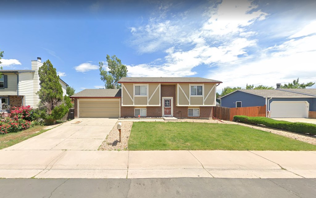 A house with a brown roof and a white garage door.