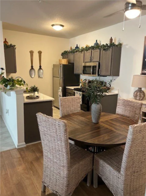 A kitchen with a table and chairs in the foreground.