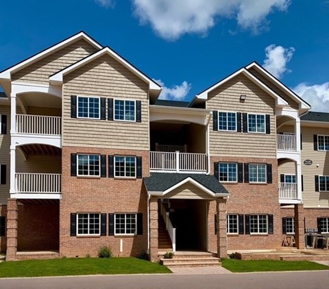 A large apartment complex with multiple balconies and windows.