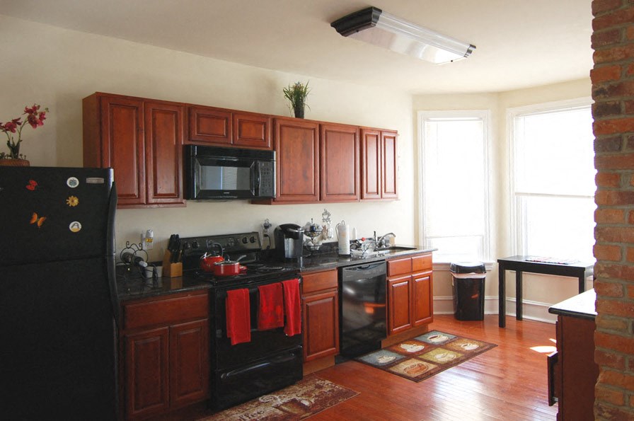 a kitchen with black appliances and wooden cabinets
