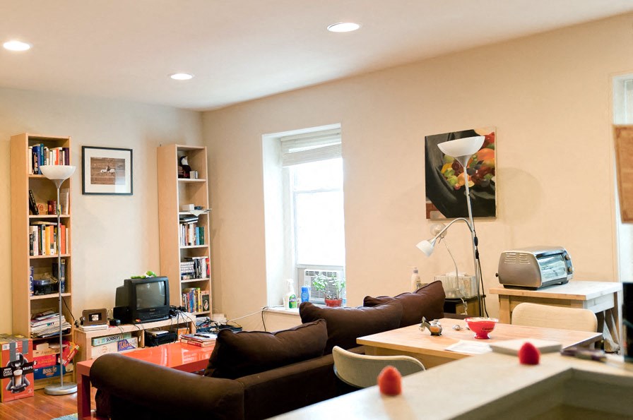 a living room with couches and a table and a television