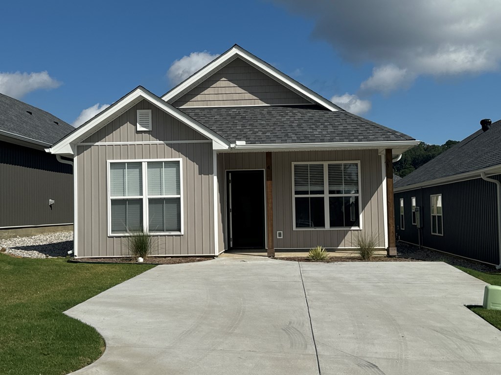 A house with a grey roof and a grey garage door.