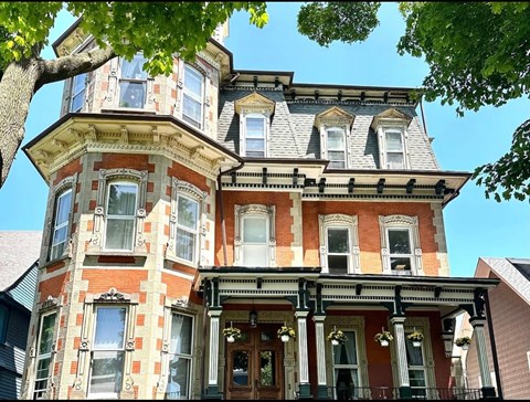 A Victorian style house with a tower and bay windows.