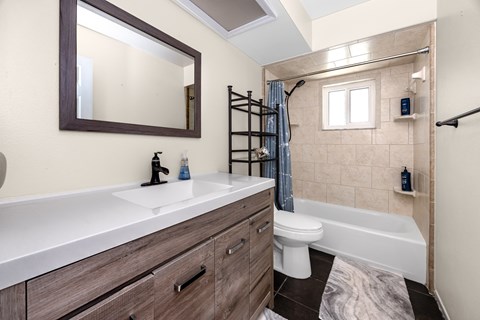A bathroom with a white sink and a white toilet.