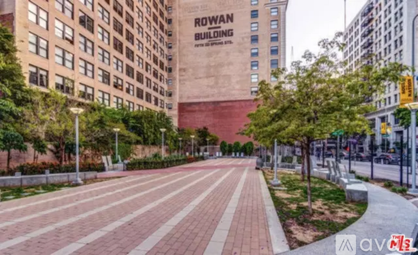A long brick walkway leads to a building with a sign that says Rowan Building.