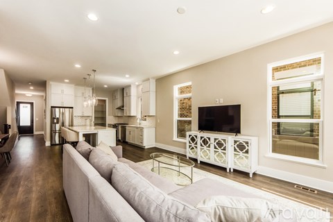 A modern living room with a white sofa and a television.