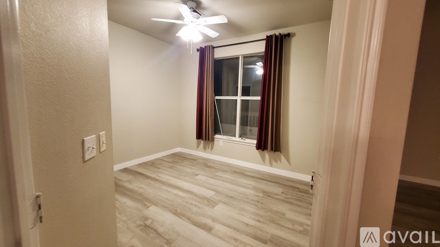 A living room with a brown couch and a television.