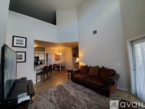 A living room with a brown couch and a television.