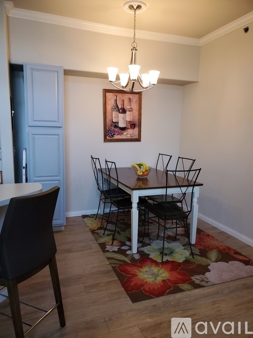 A dining room with a table and chairs.