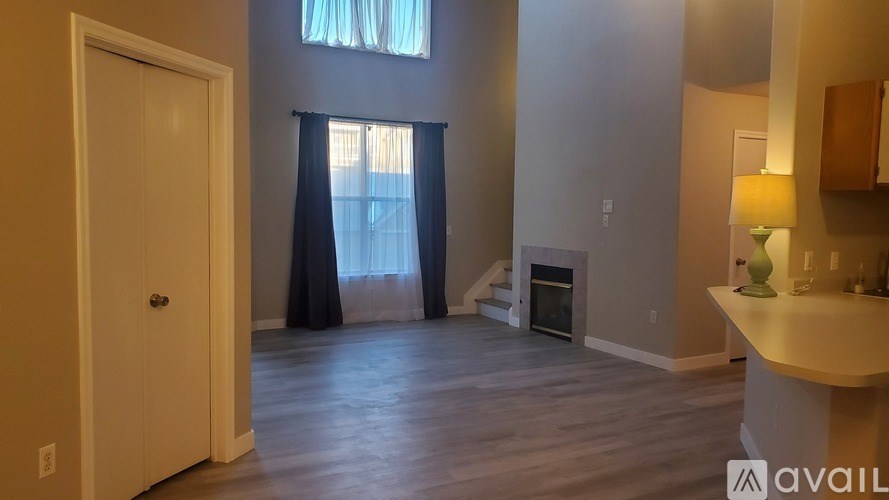 A dining room with a table and chairs.