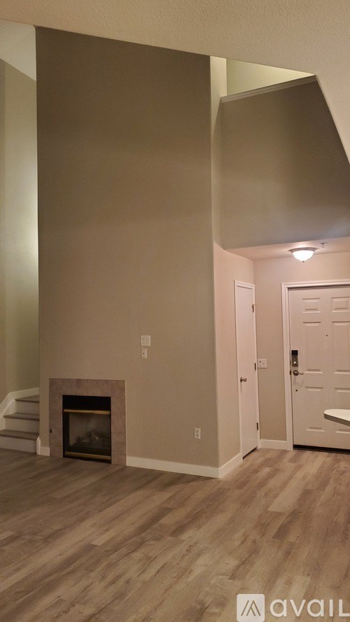 A kitchen with a white island and brown chairs.