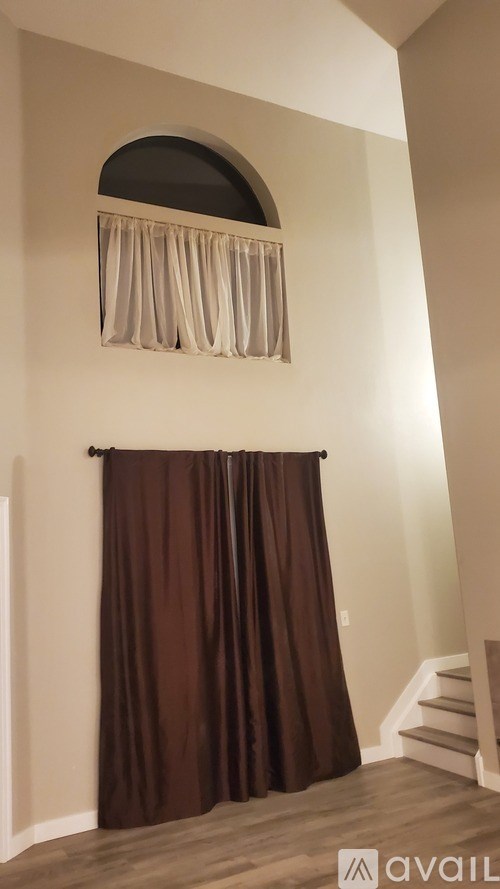 A kitchen pantry with a white fridge, a white microwave, a white dishwasher, and a black trash can.