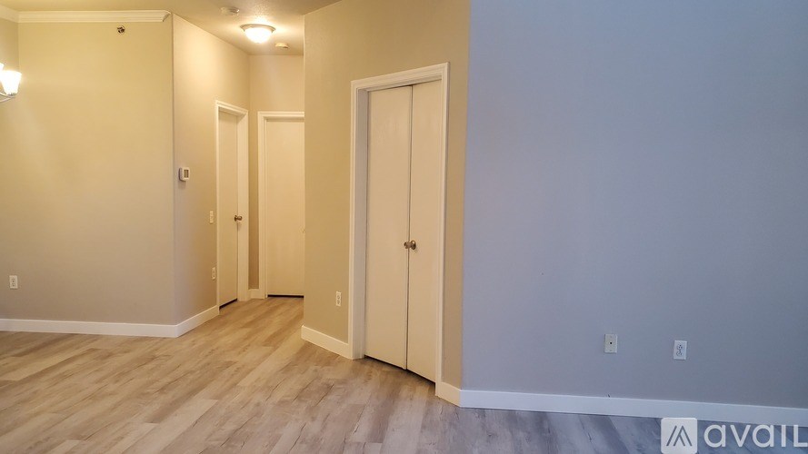 A bathroom with a white sink and orange towels.
