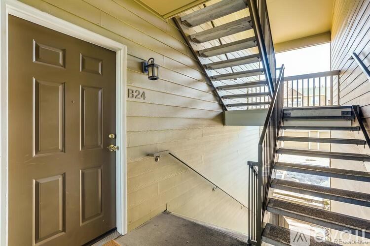 A brown door with the number B24 on the wall above it.