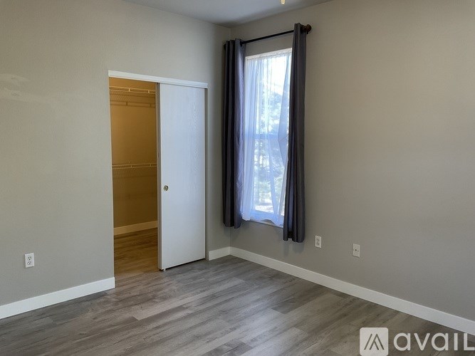 A kitchen area with a counter and a fridge.