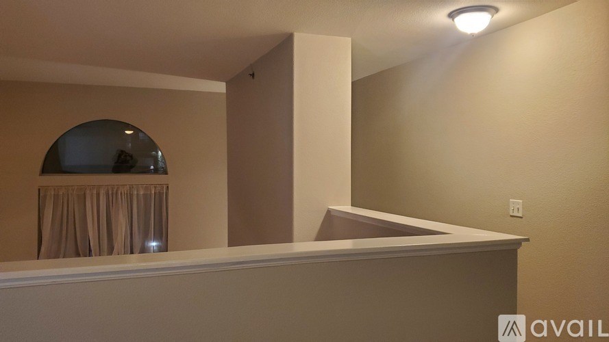 A room with a curtain and a mirror on the wall.