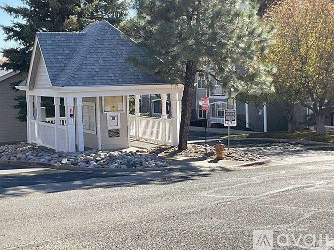 A balcony with a white railing and a rug on the floor.