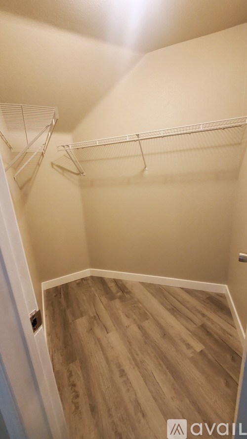 A room with a wooden floor and white walls.