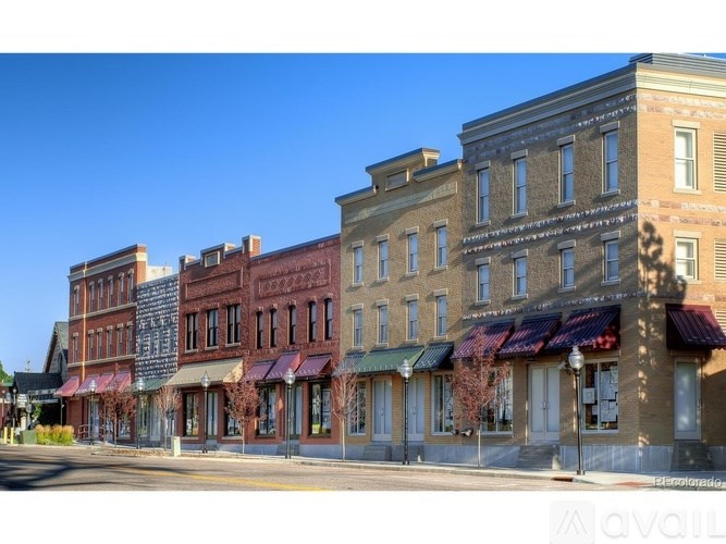 A row of old buildings with a clear blue sky above them.