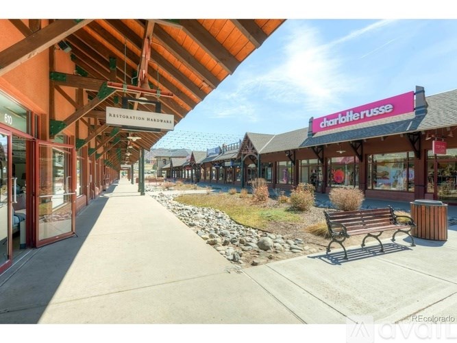 A long covered walkway with a sign for Charlotte Russe.