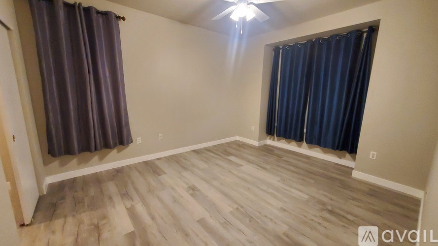 A lamp sits on a nightstand next to a bed.