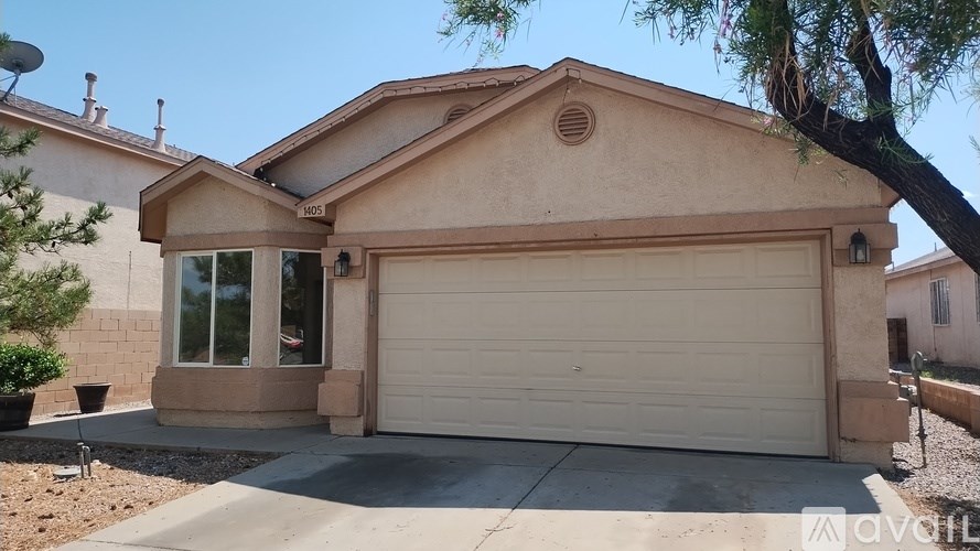 A house with a garage and a driveway in front.