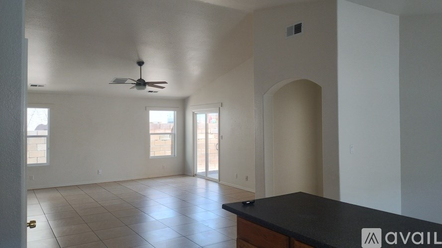 A spacious room with a fan and a counter is available for rent.