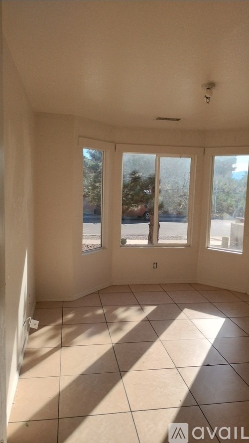 A room with a large window and a tiled floor.