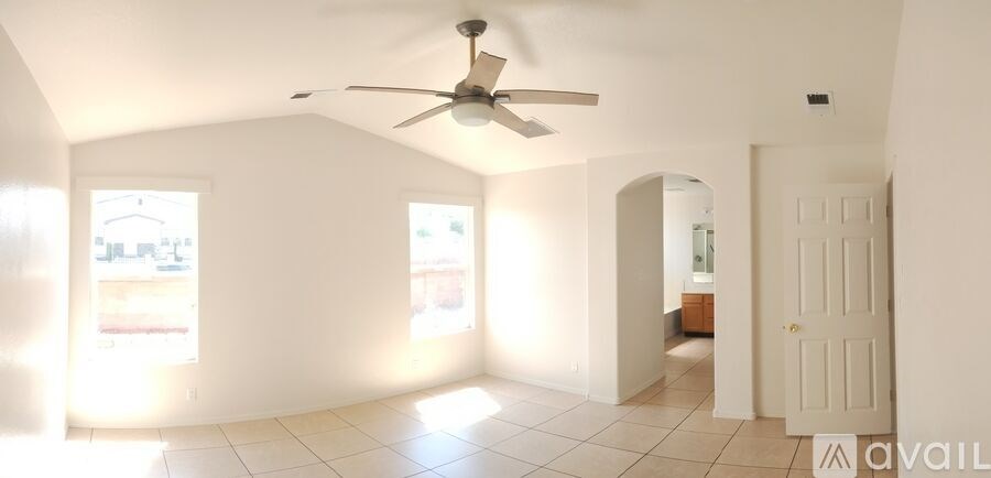 A room with a fan and a door.