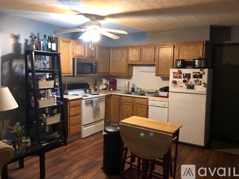 A kitchen with wooden cabinets and a white refrigerator.