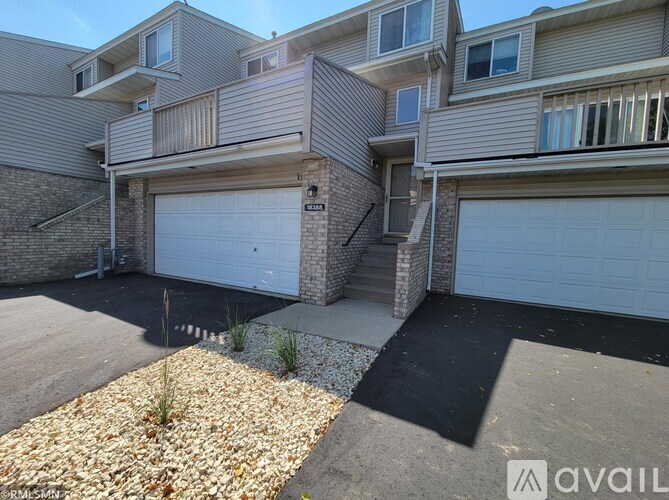 A building with a garage door is available for rent.
