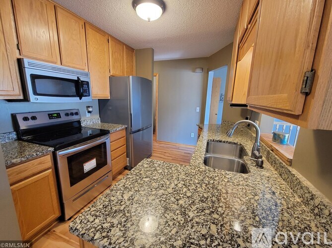 A kitchen with granite countertops and stainless steel appliances.