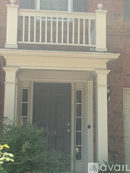 A black door with a glass window and a sign that says "available" in front of it.