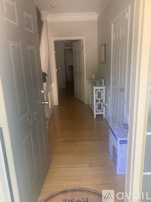 A long hallway with a rug on the floor that says "Thailand" on it.