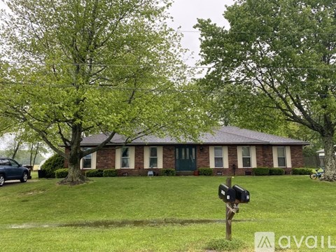 A house with a green door and a mailbox in front.