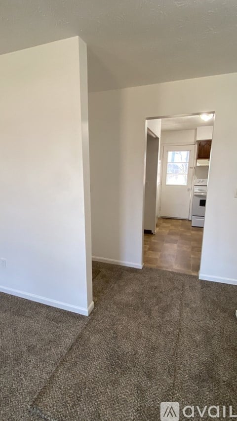 A room with a carpeted floor and white walls.
